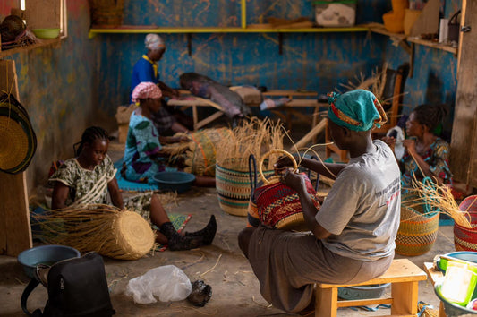 Ghanaian artisans hand-weaving Bolgatanga baskets from elephant grass in northern Ghana