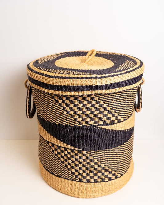 Bolga laundry basket with fitted lid on, two leather-wrapped handles, handwoven in Ghana