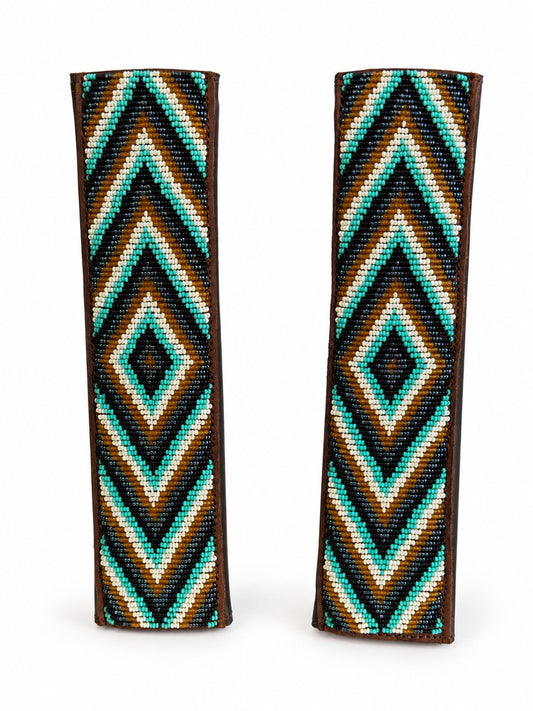 Two turquoise and gold beaded seat belt covers at an angle, handmade in Kenya