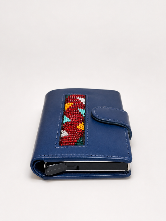 Side profile of blue handmade leather RFID wallet showing Maasai beadwork panel, card ejector and snap closure