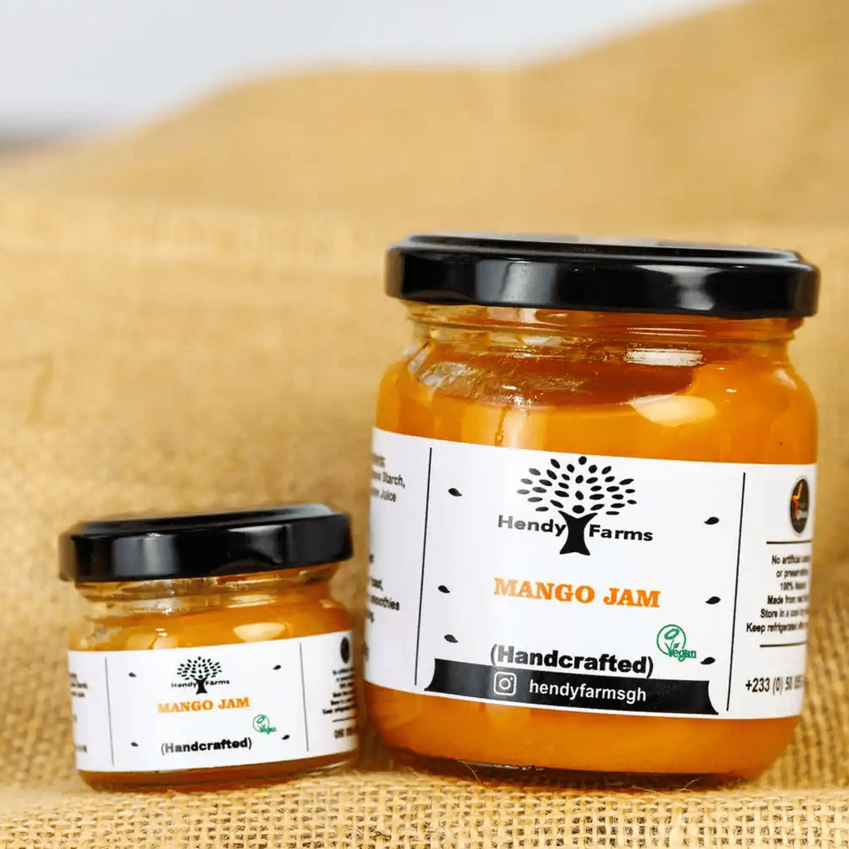 Large and mini jars of Hendy Farms handcrafted mango jam from Ghana on natural hessian