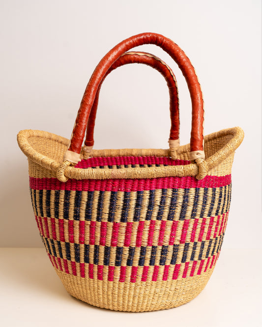 Woven basket with red and black pattern on a white background