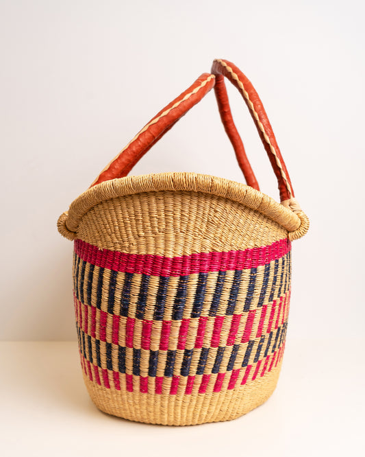 Woven basket with red and blue striped pattern on a white background