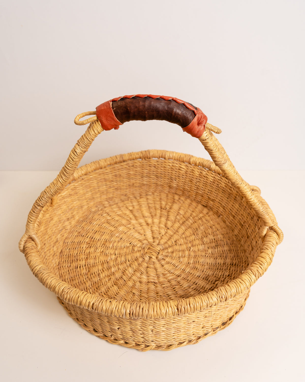 Top view of a Bolga tray basket showing the round woven base