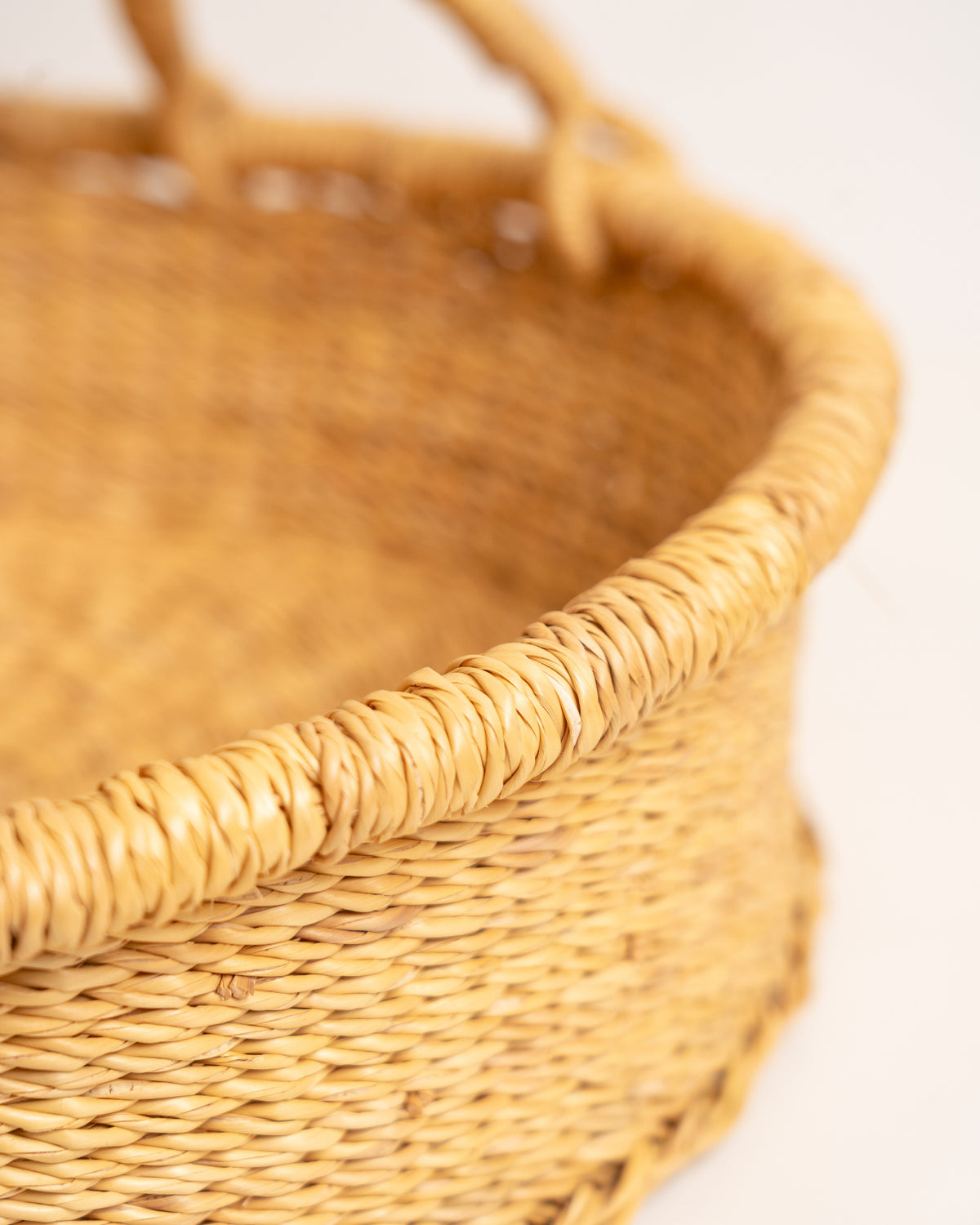 Close-up of the woven rim of a Bolga tray basket