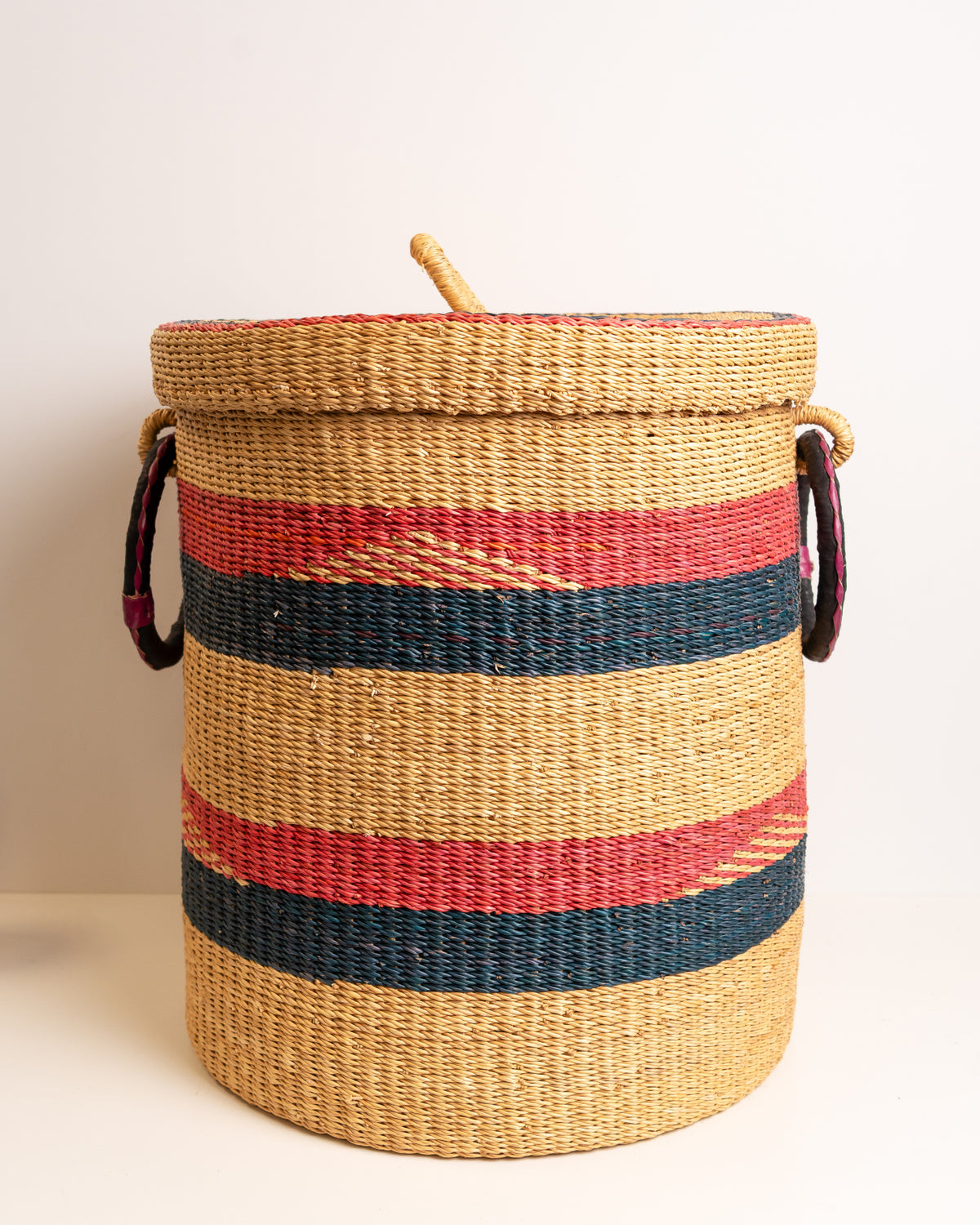 Ethical handmade Bolga laundry basket, red and navy striped elephant grass storage hamper with lid, handwoven in Ghana