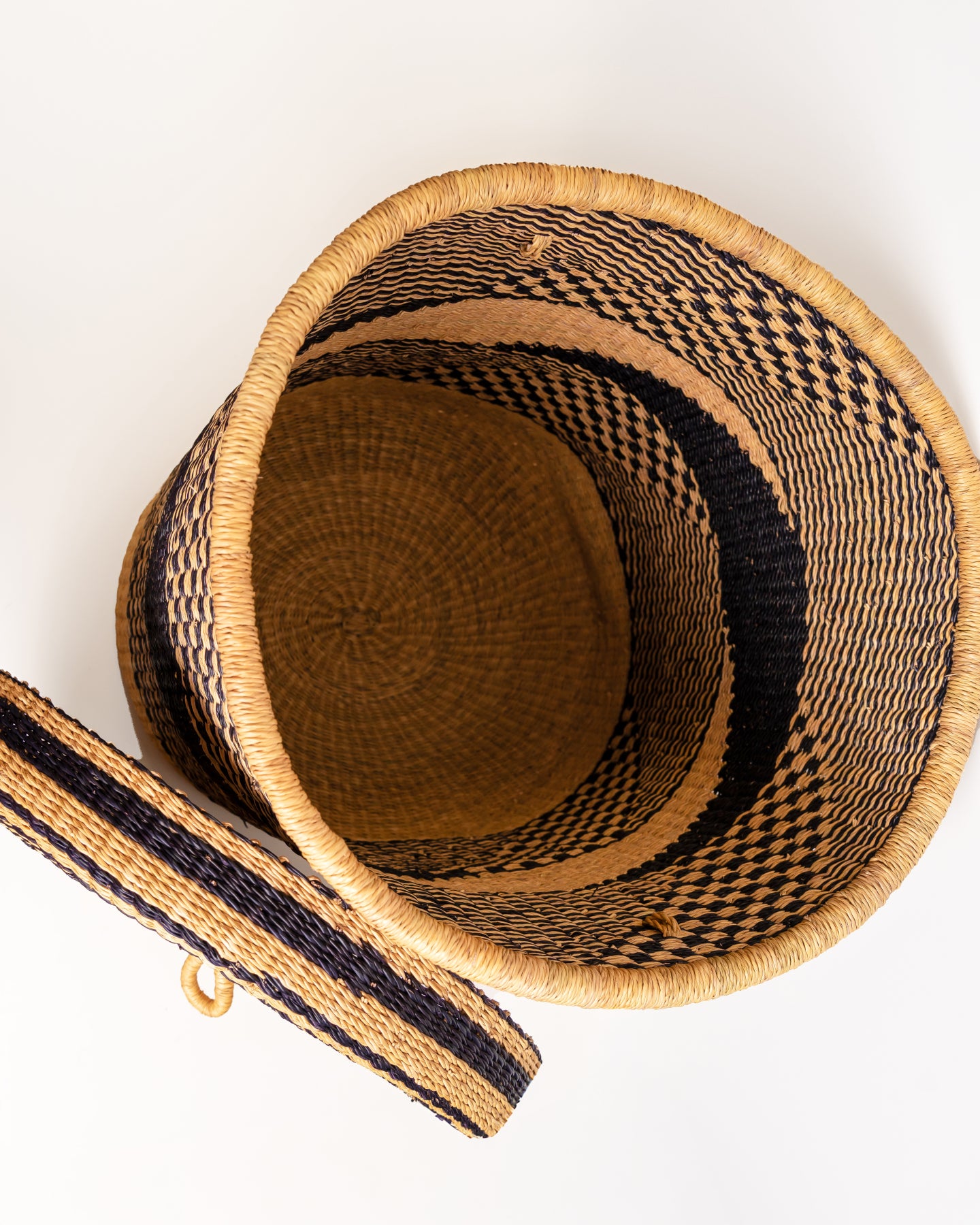 Inside a handwoven Bolga laundry basket with lid removed, woven elephant grass interior and carry strap, Ghana