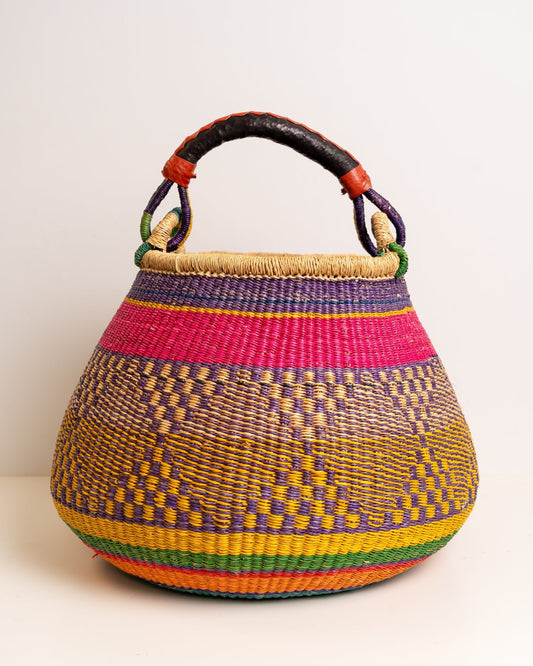Pink and purple Ahoufe Bolga pot basket handwoven from elephant grass in Ghana, shown from the front.
