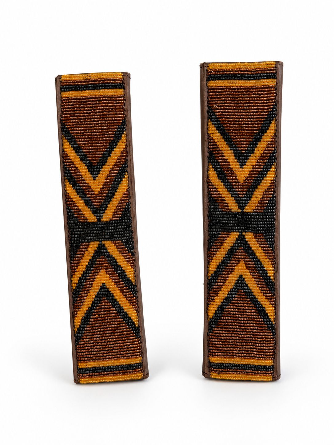 Two amber and black beaded seat belt covers side by side showing the brown leather edging