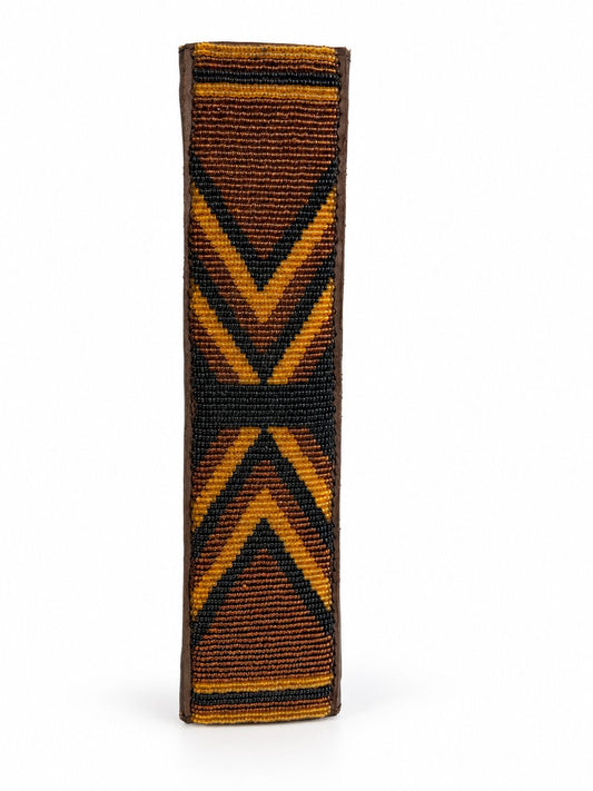 Amber and black Maasai beaded seat belt cover with crossed gold chevrons, handmade in Kenya