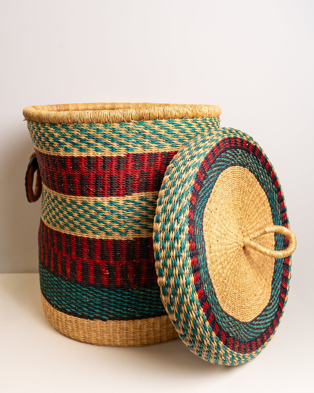Bolga laundry basket with lid removed, showing red, teal and black woven stripe interior, handwoven elephant grass, Ghana