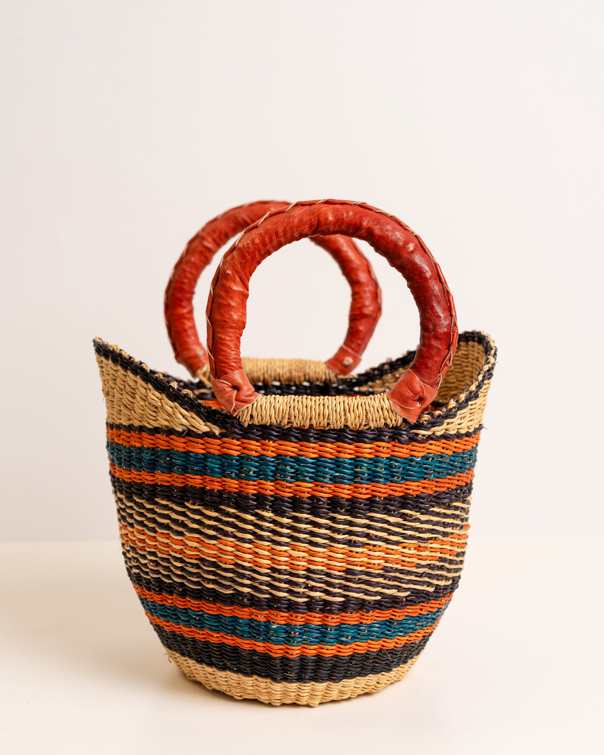 Mini Bolga market basket in natural elephant grass with bold striped weave and leather-wrapped handles, Ghana