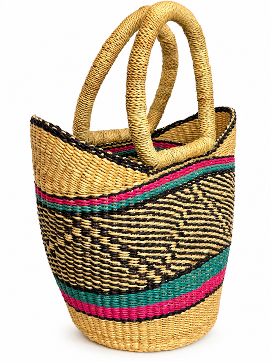 Side view of a leather-free Bolga basket with grass-wrapped round handles and fuchsia and teal stripes