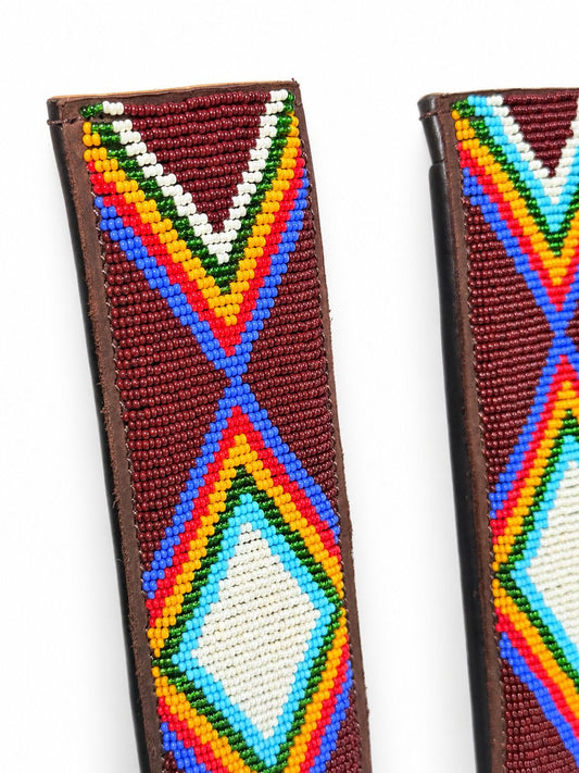 Close-up of hand-stitched glass beads on a maroon Maasai seat belt cover