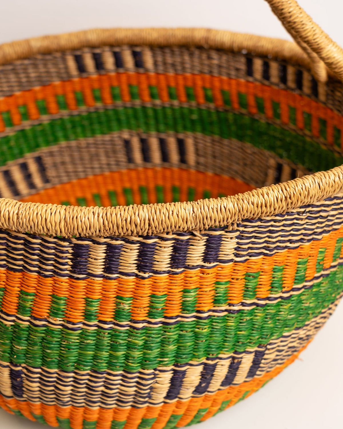 Obaa Sima hand-woven round basket — Woman of Substance, vibrant ethical Ghanaian artisan basket