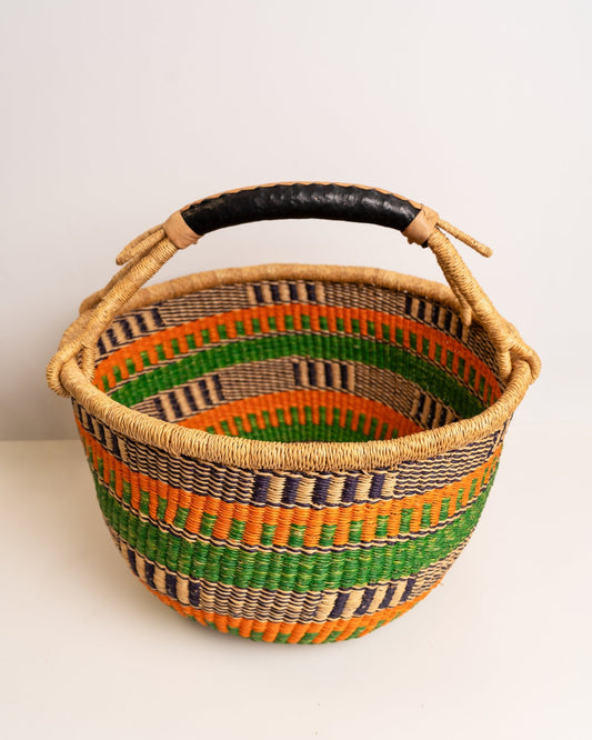 Obaa Sima hand-woven round basket — Woman of Substance, vibrant ethical Ghanaian artisan basket