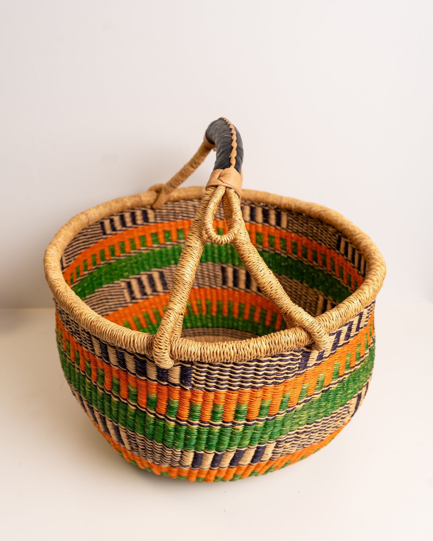 Obaa Sima hand-woven round basket — Woman of Substance, vibrant ethical Ghanaian artisan basket
