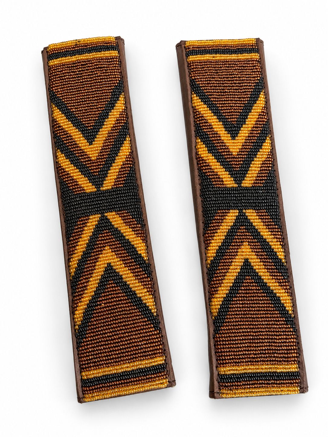 Two amber and black beaded seat belt covers at an angle, handmade in Kenya