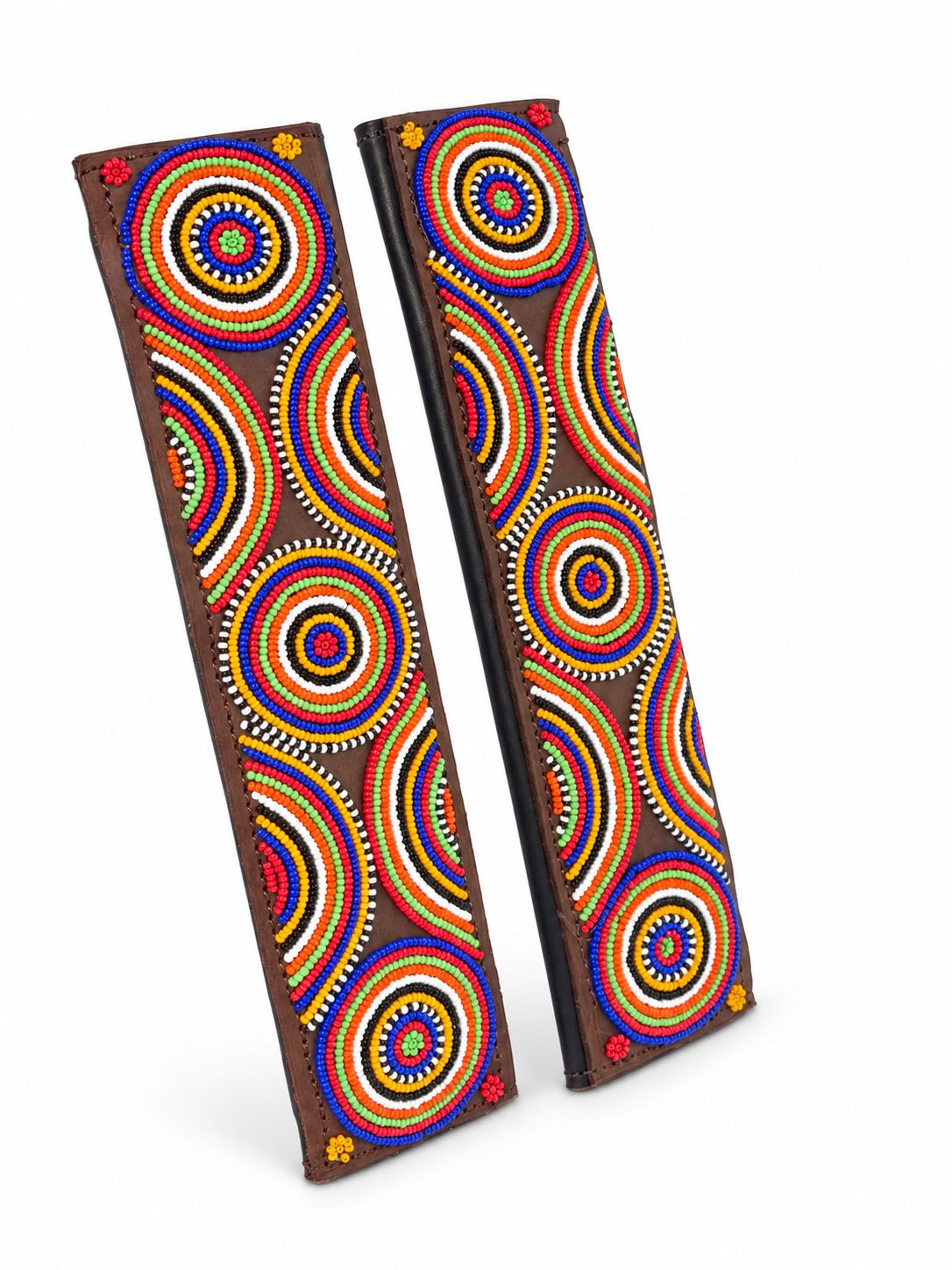 Two brown beaded seat belt covers at an angle showing the leather backing