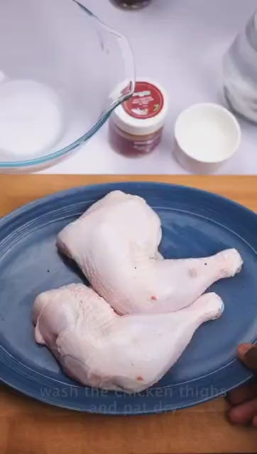 Seasoning raw chicken thighs with Miss Cookie Ghanaian dry rub, a step-by-step African spice marinade recipe
