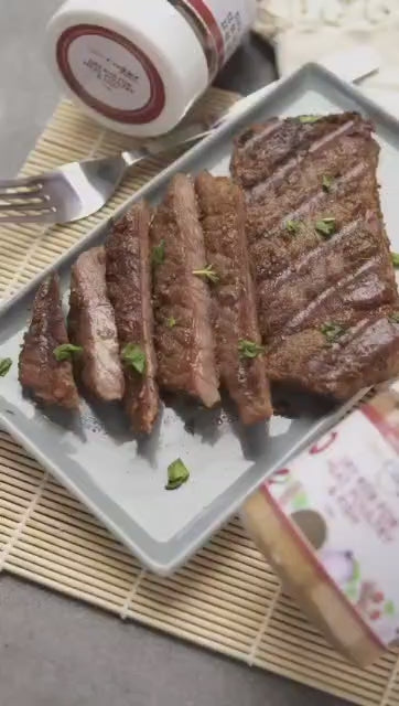 Grilled beef steak seasoned with Miss Cookie Ghanaian dry rub, sliced and served on a white plate