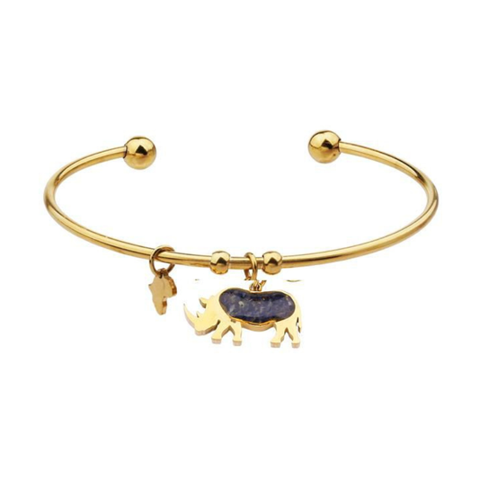 Gold-plated open cuff rhino bangle with a rhino charm set with blue sodalite inlay and a small Africa-shaped charm, on a plain white background.
