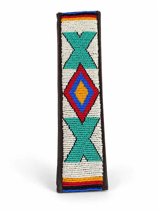 Side view of a cream and turquoise beaded seat belt cover showing the brown leather edging